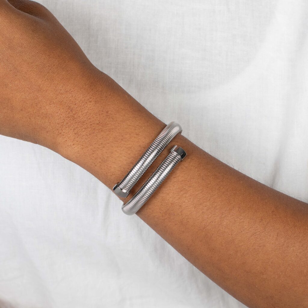 Stainless steel Tamia Cuff Bracelet worn alone against a soft white top—simple, modern, and elegant.