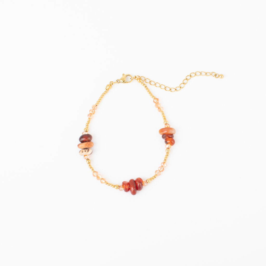 Cora gold stainless bracelet with natural carnelian stones in rust, amber, peach, and deep red tones.