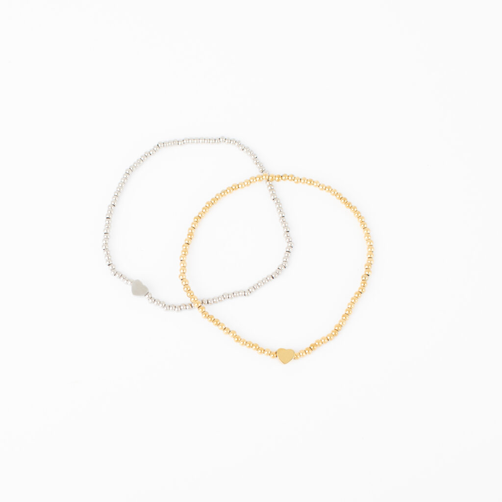 Gold and silver Florence stretch bracelets featuring polished beads and a small heart accent on a white background.
