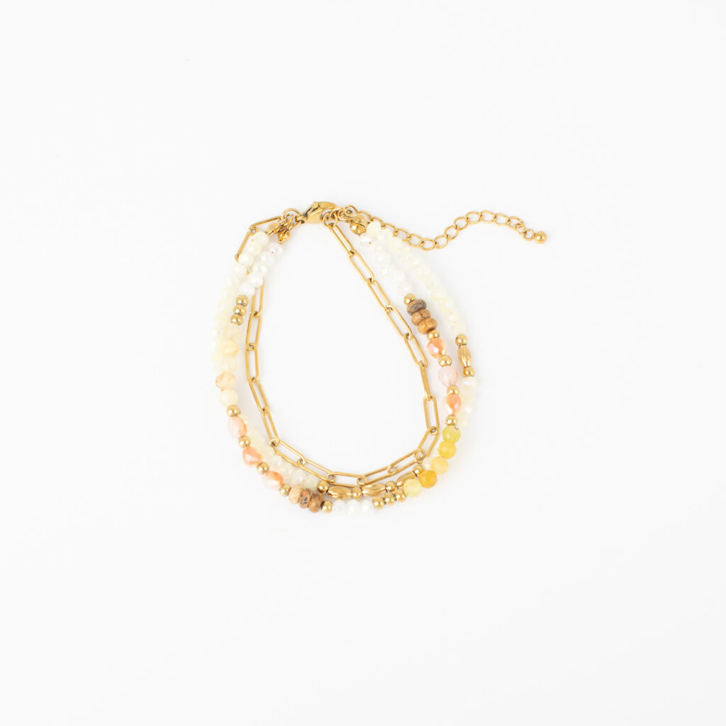 Gold Liza three-strand bracelet featuring a paperclip chain and faceted beads in soft ivory, blush, and golden tones.