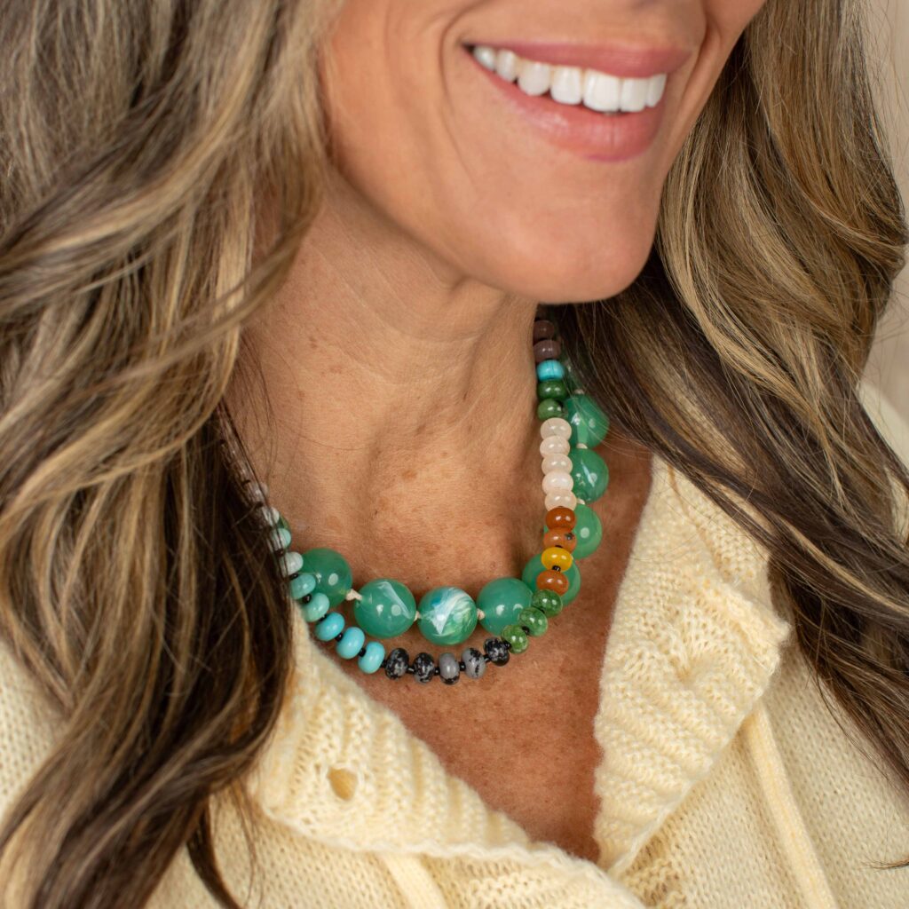The Briar oversized green bead necklace layered with a colorful natural stone necklace, demonstrating one of the biggest jewelry trends for Fall 2026—mixing chunky statement beads with smaller layered strands.