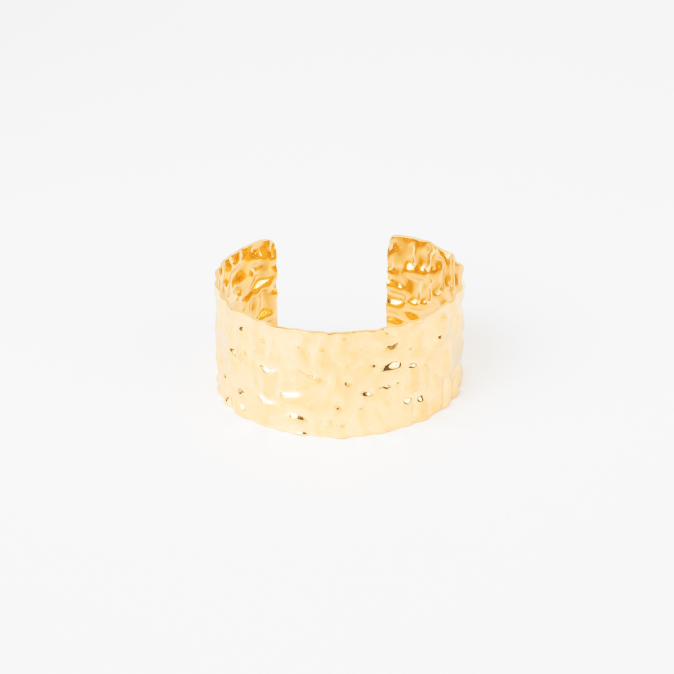 Wide Elle gold stainless steel cuff bracelet with a textured hammered finish.