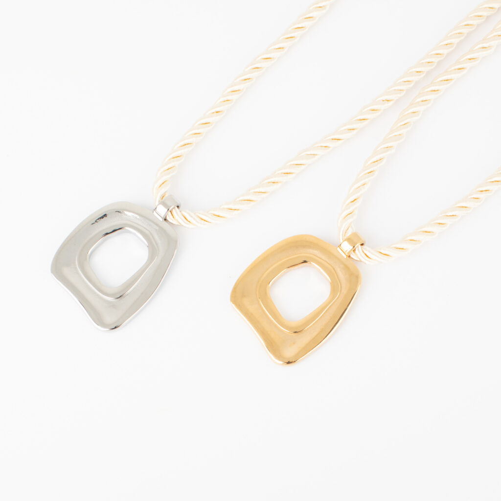 Gold and silver Louisa necklaces featuring cream twisted cords and open sculptural pendants on a white background.