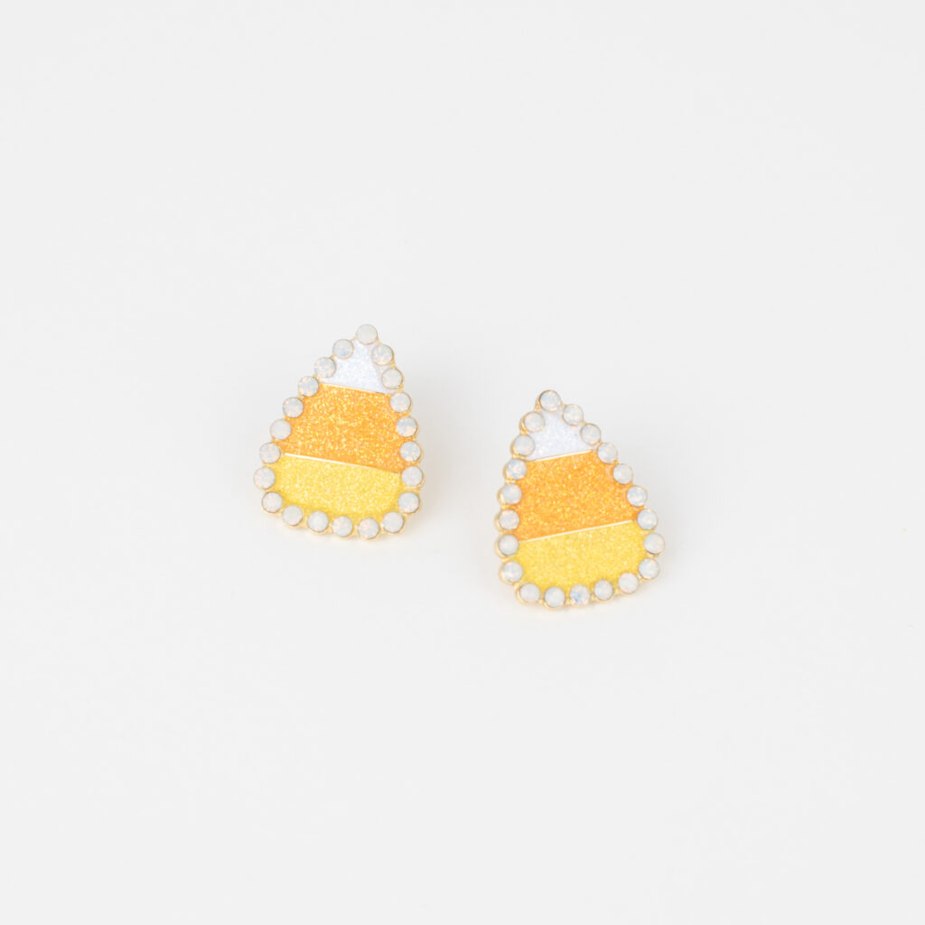 Orange, yellow, and white candy corn earrings bordered with small sparkling stones.