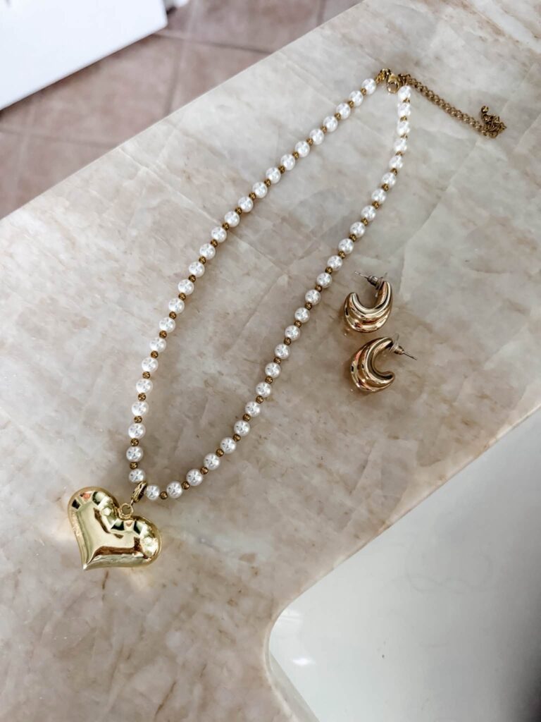Asher pearl necklace styled with the Bubble Heart Charm and James Earrings.