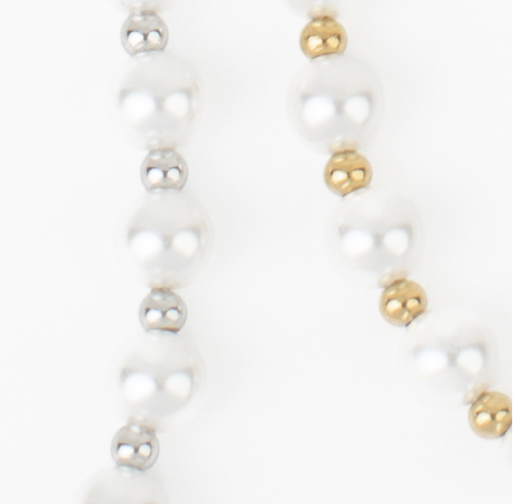 Close-up of the Asher Necklace showing imitation pearls and small metallic accents.