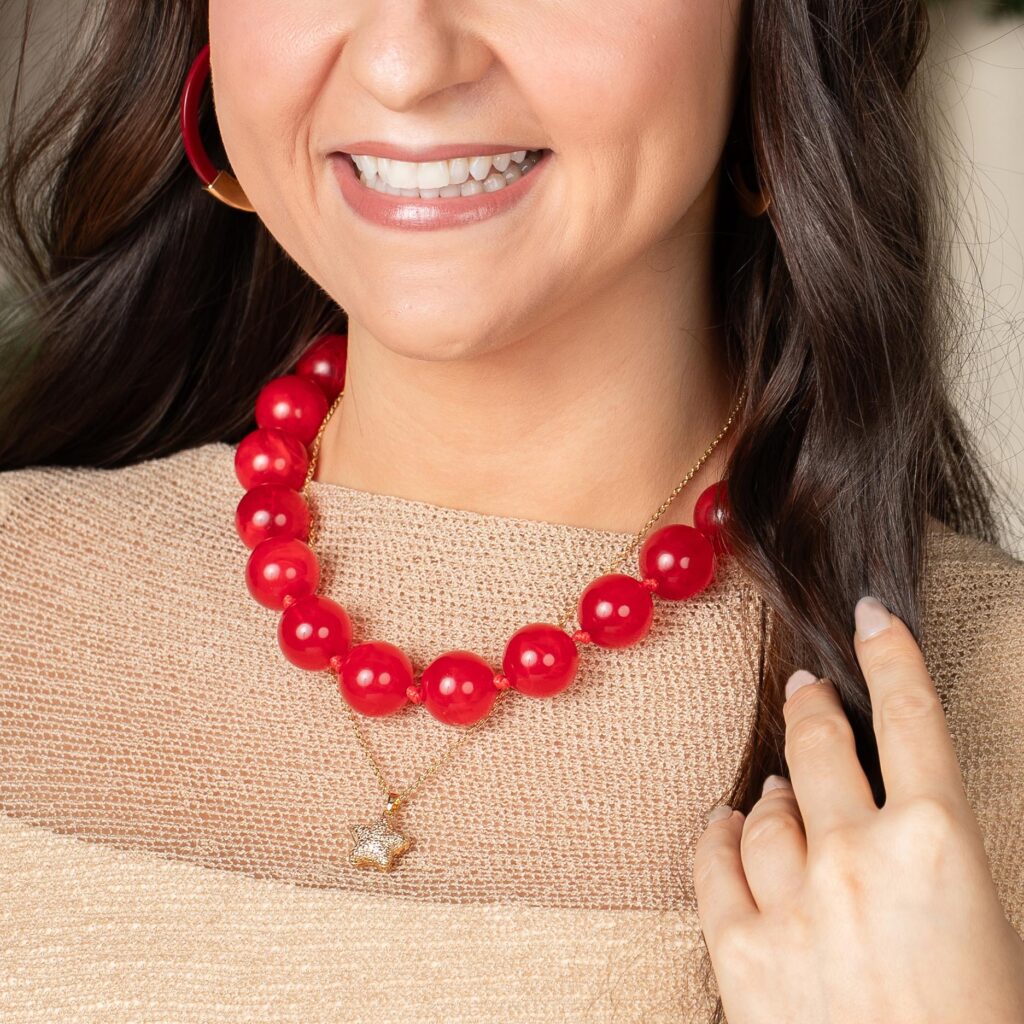 Cherry Bauble Necklace worn over a neutral top with separate layered jewelry