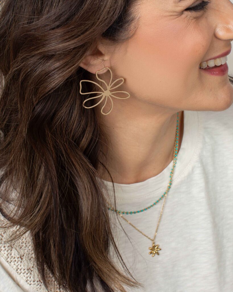 Ciara layered gold necklace with turquoise-colored accents and a floral pendant