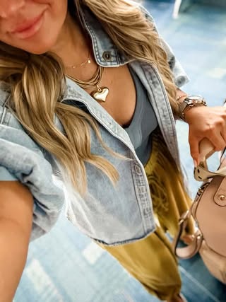 Casual denim outfit styled with the Dawn layered necklace and a gold heart pendant.
