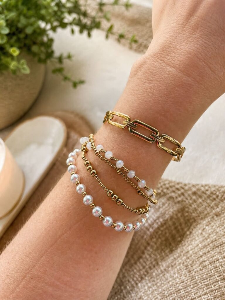 Gold Nara link-style cuff worn with separate beaded bracelets