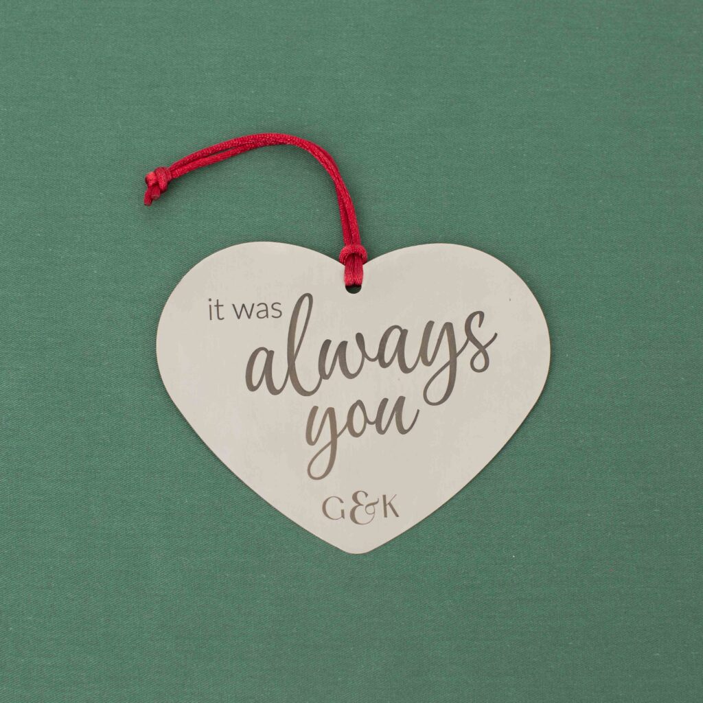 Heart-shaped stainless steel ornament engraved with it was always you and initials